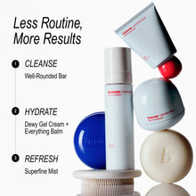 A set of bicocei skincare products arranged on a white background with marketing text on the left. The products include a Well-Rounded Bar, Dewy Gel Cream, Everything Balm, and Superfine Mist in white, blue, and cream tones, with one red accent piece.
