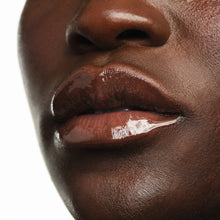 Close-up of glossy deep brown lips wearing Jelly Gloss