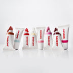 Eight Jelly Gloss squeeze tubes in different shades lined up on a white surface