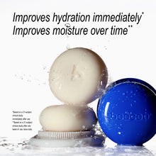 Two beecee skincare products shown in a water-splash studio setup: a round soap bar product on a white applicator base and a blue soap case with embossed branding. Large text at the top reads, 'Improves hydration immediately.