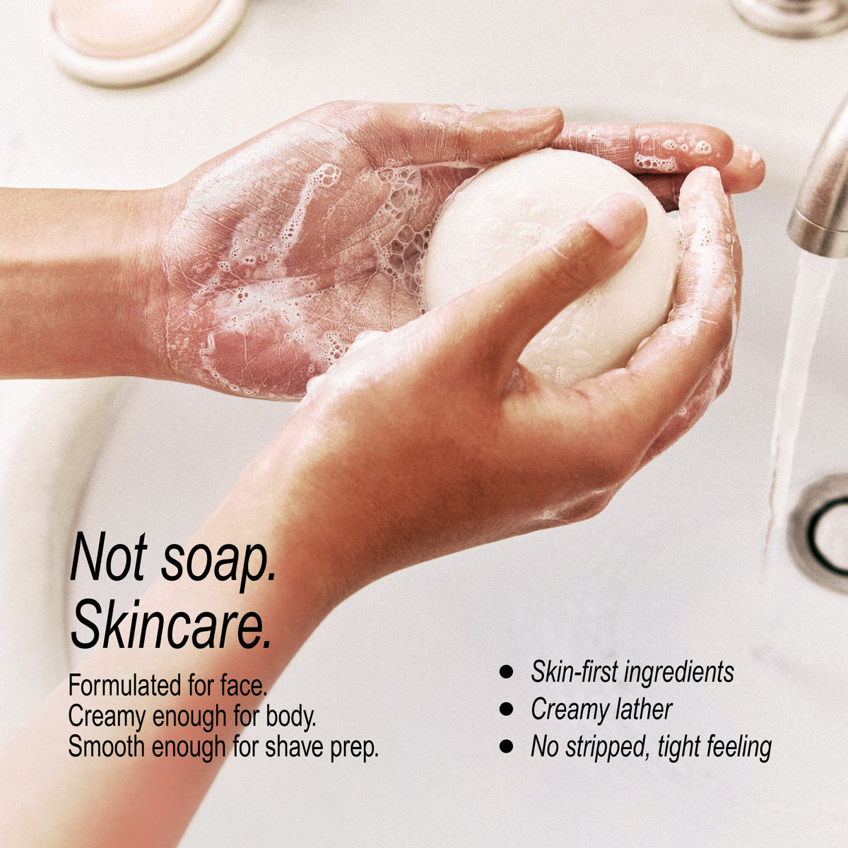 A person's hands lathered with soap wash are holding a round bar of shaving soap over a running faucet in a sink. Text on the image reads 'Not soap.