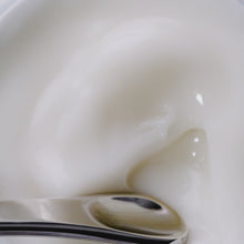 A video of the dewy gel cream being stirred with a silver spatula. 